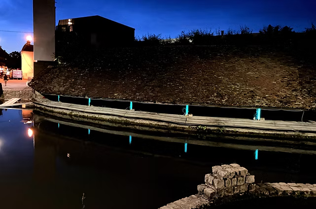 Walking path lights up with bioluminescent poles in the city of sens